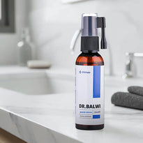 Eine Flasche Dr. Balwi Beard Serum von Elithair steht auf einem Marmortisch im Badezimmer. Im Hintergrund sind ein unscharfes Handtuch, eine Lotionflasche und ein Seifenspender zu sehen.